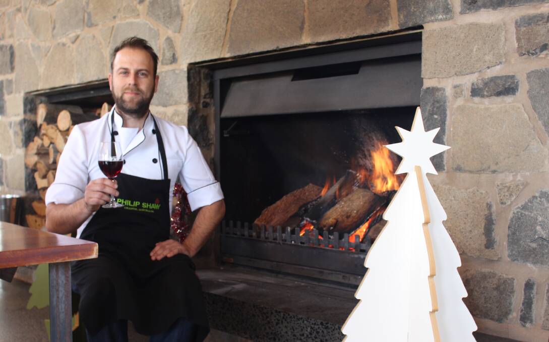 WARM UP: Philip Shaw Wines chef Francesco Zarrella warming up with a glass of wine by the fire ahead of this weekend's Christmas in July. Photo: MAX STAINKAMPH