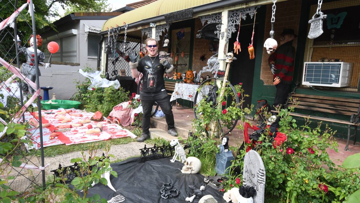 READY FOR ACTION: Luke Rout in the garden of his house on Nile Street, which is vying for the title of spookiest in Orange. Photo: JUDE KEOGH