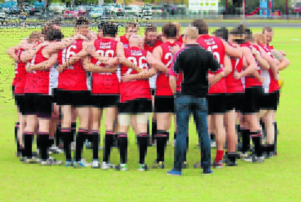 WILL THEY BE BACK: Mudgee Black Swans in a huddle in 2014. 