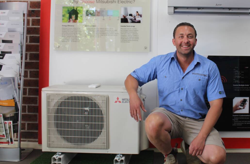 IN DEMAND: Tilstons Electrical's Adrian Bond next to the hottest commodity in town during Orange's heatwave - an air conditioner. Photo: MAX STAINKAMPH