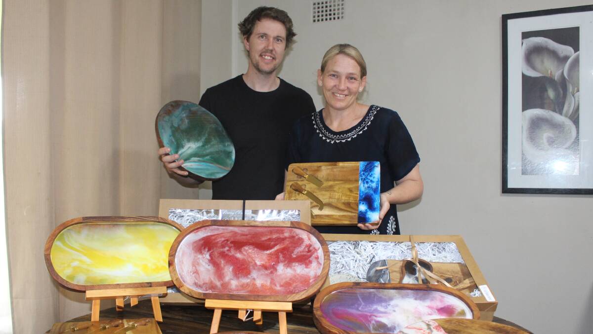 RHYME AND RESIN: Jed Ford and Jo Quinn with some of the resin art they've been selling across the region. Photo: MAX STAINKAMPH 1007MSresin1