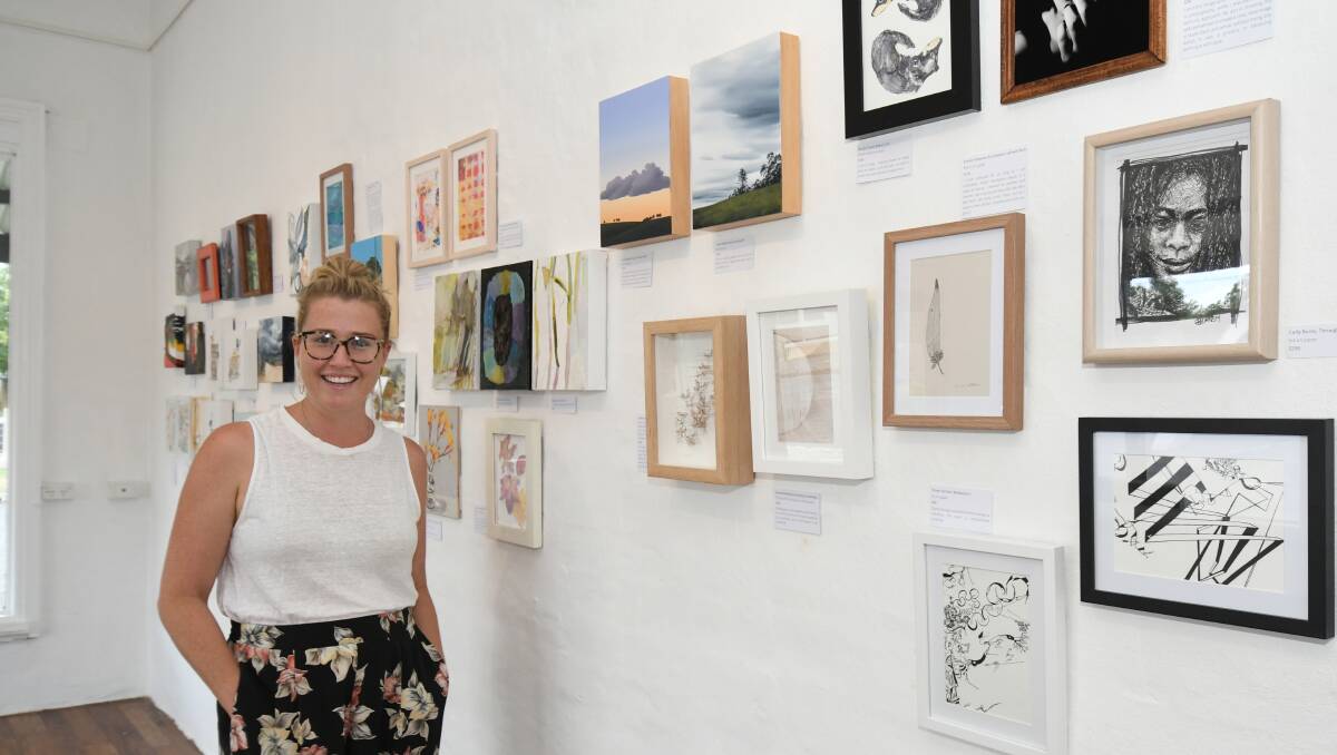 ALL THE ARTWORK: The Corner Store Gallery's Madi Holborow with some of the pieces on display at the exhibition. It will be open for the next two weeks. Photo: JUDE KEOGH