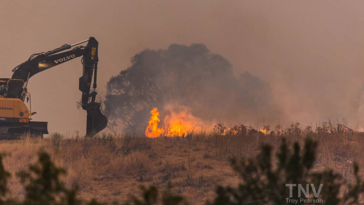 ABLAZE: Vegetation and green waste caught alight at the Orange tip on Sunday evening. Photo: TROY PEARSON/TOP NOTCH VIDEO