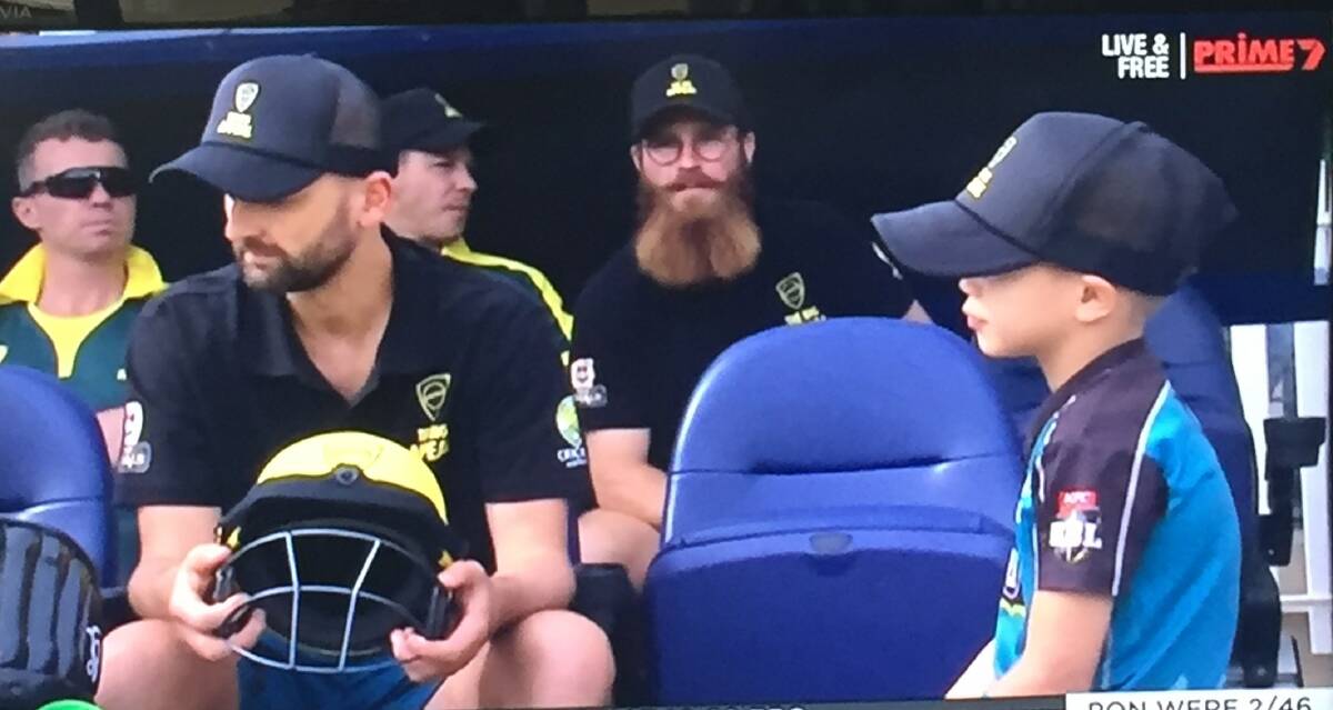 BEARD ON TV: Angus Le Lievre and his impressive beard sitting near Tim Paine, Peter Siddle and behind Nathan Lyon in the dugout on Sunday. 