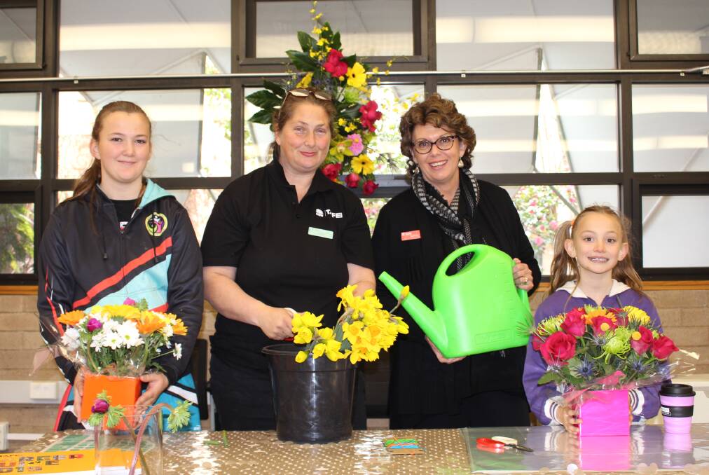 FLOWERS: Mitika Fraser, Sarah Cox, Robyn Hall and Tiffany Fraser at the TAFE NSW Orange campus on Saturday. Photo: MAX STAINKAMPH 0818MStafe1