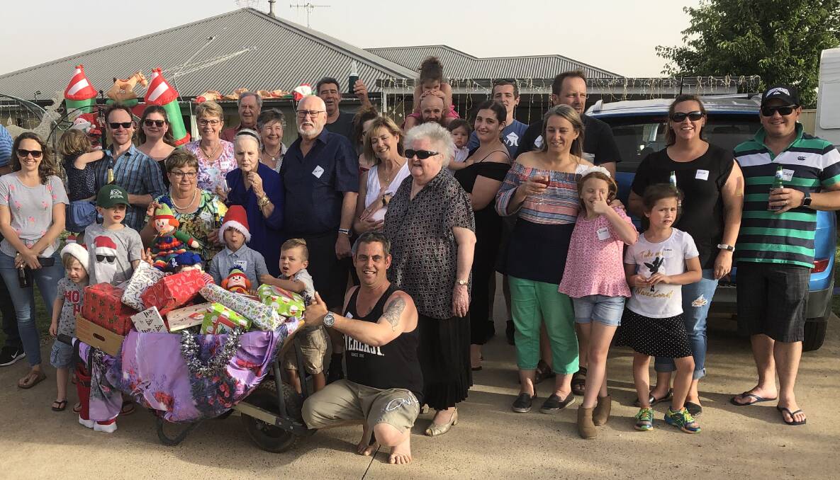 COMMUNITY SPIRIT: The residents of Valencia Drive banded together to donate a wheelbarrow full of presents for those in need this Christmas. Photo: SUPPLIED