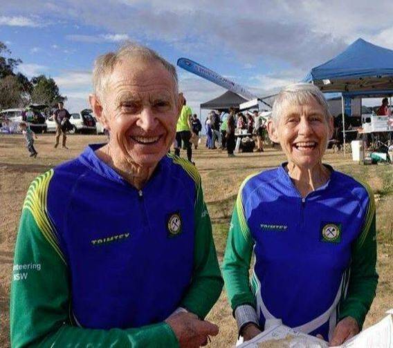 STILL GOING STRONG: Basil and Jean Baldwin in action with maps in hand at an Orienteering event. Photo: SUPPLIED.