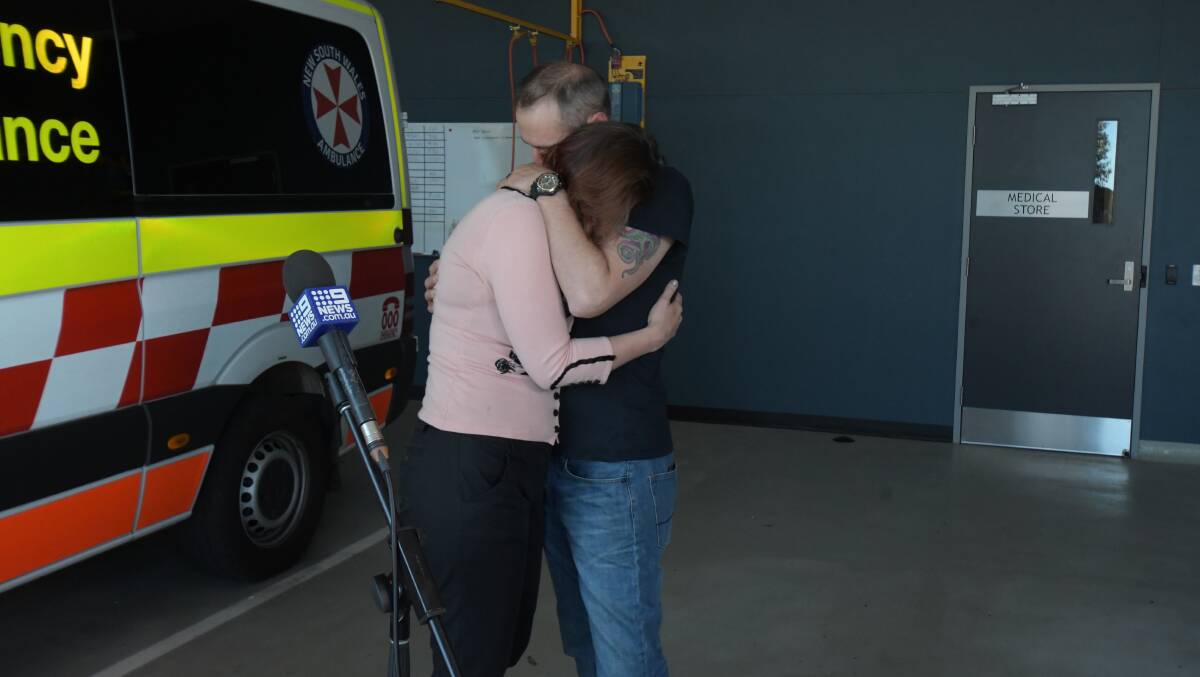 HELD CLOSE: Steve Dickie and Guinevere Missingham embrace after recounting the night the former nearly lost his life. Photo: JUDE KEOGH