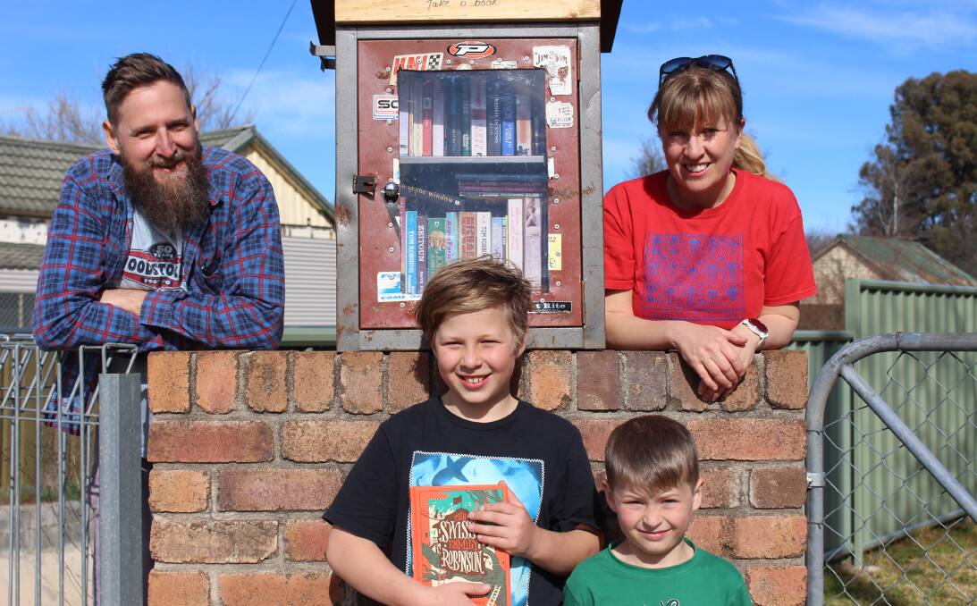 BOOKS ON OFFER: Steve, Kelly, Rowan and Kilty Mason Kerr with their street library they constructed during lockdown. Photo: MAX STAINKAMPH