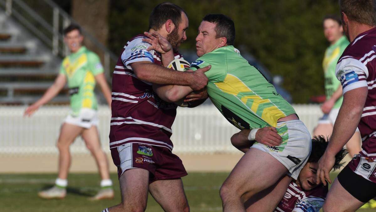 BREAK FREE: CYMS' Tim Mortimer tries to break through a Bears tackle last year at Wade Park. 