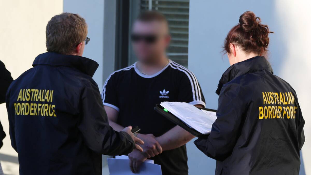 INVESTIGATION: Australian Border Force officers speak with a man at the scene of a joint agency operation in South Bathurst on Wednesday. Photo: NSW POLICE FORCE