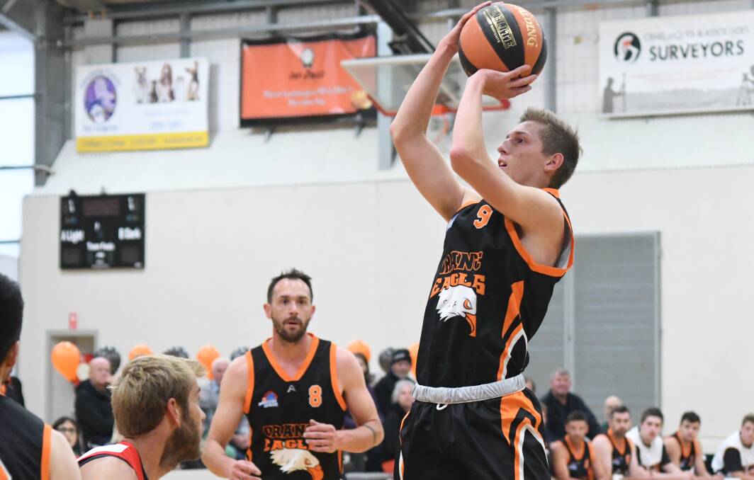 SHOT UP: Orange Eagles' Kobe Mansell shoots during their last game in Orange as captain Mitch Selwood watched on. Mansell top-scored for his side in Lithgow. Photo: JUDE KEOGH
