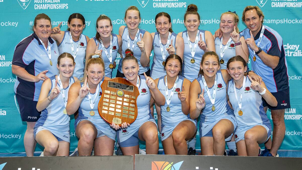 NUMBER ONE: Chloe Barrett holds the shield up with co-captain Emma Corcoran after NSW's 7-2 victory in the under 21s final. Photo: CLICK IN FOCUS. 