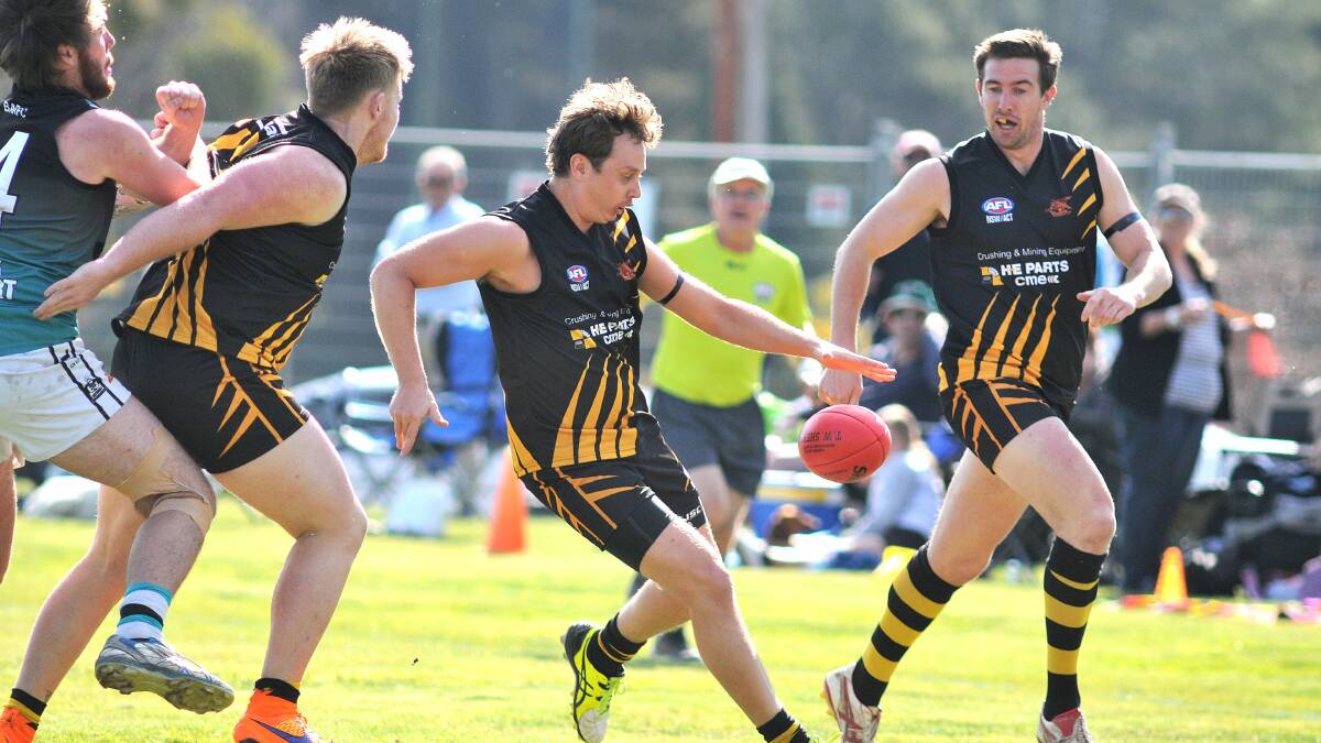ON THE BOOT: Tigers forward Dale Hunter plonks the ball on his reliable left boot as Tim Barry looks on in the 2015 grand final. Photo: STEVE GOSCH