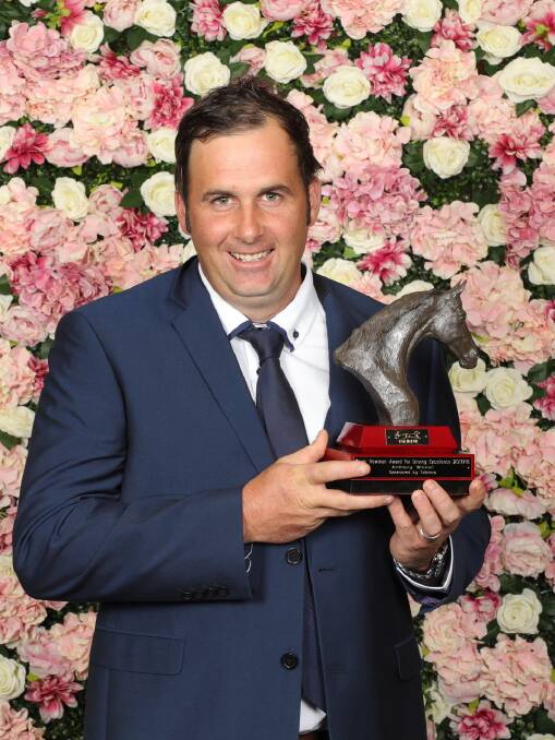 SCRUBS UP ALRIGHT: Spring Hill trainer Anthony Winnell holding the TAB Kevin Newman Award For Driving Excellence on Saturday night. Photo: HARNESS RACING NSW. 