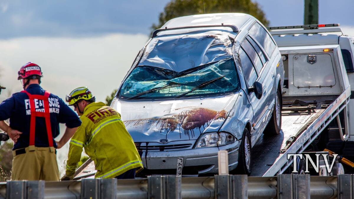 SMASHED: The car which rolled near the Northern Distributor on Sunday. Photo: TROY PEARSON/TOP NOTCH VIDEO