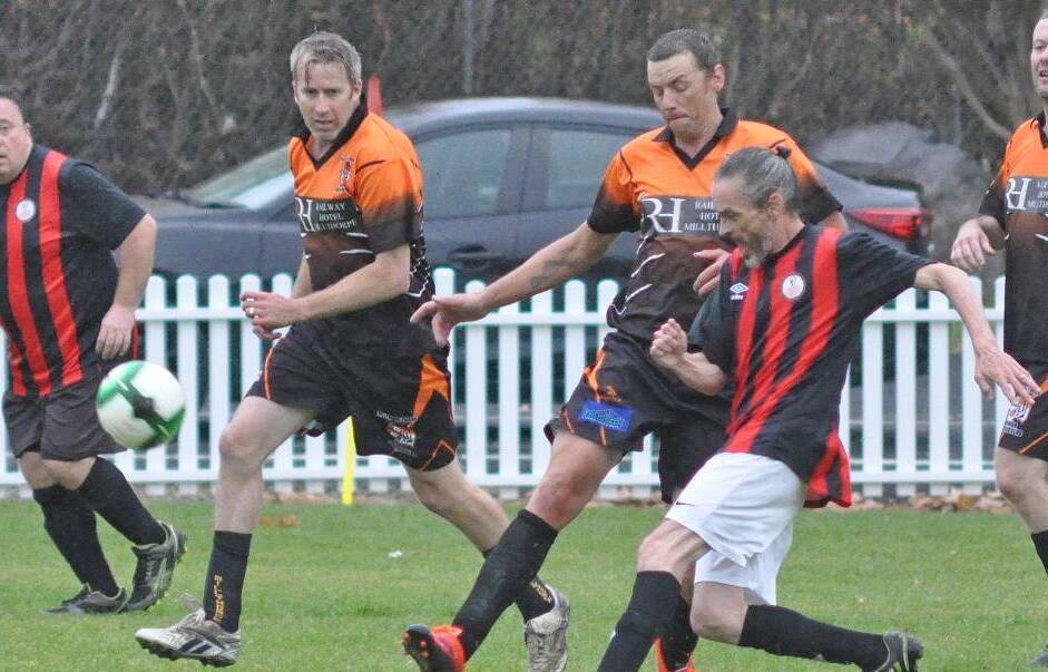 STILL NO WORD: Tom Grinter, David Coles and Nick Hyndes battle for possession at Redmond Oval in Millthorpe. There's still no word on their competition recommencing. 