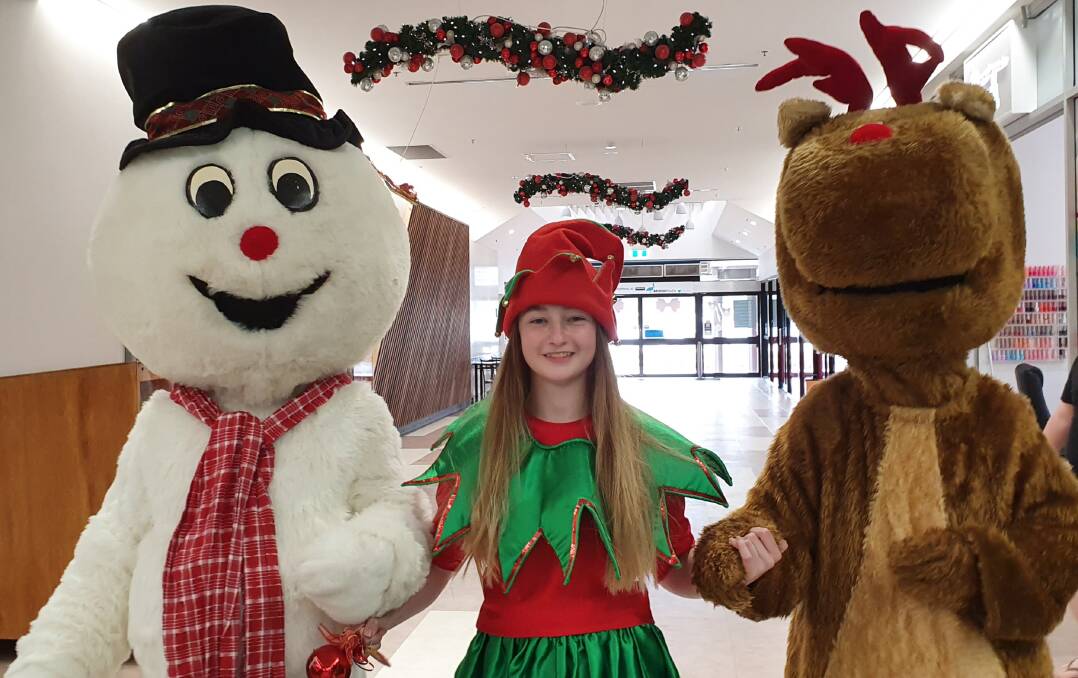 FESTIVE SPIRIT: Elf Sophie Minogue with Frosty the Snowman and Rudolph ahead of Saturday's Santa breakfast. Photo: SUPPLIED. 
