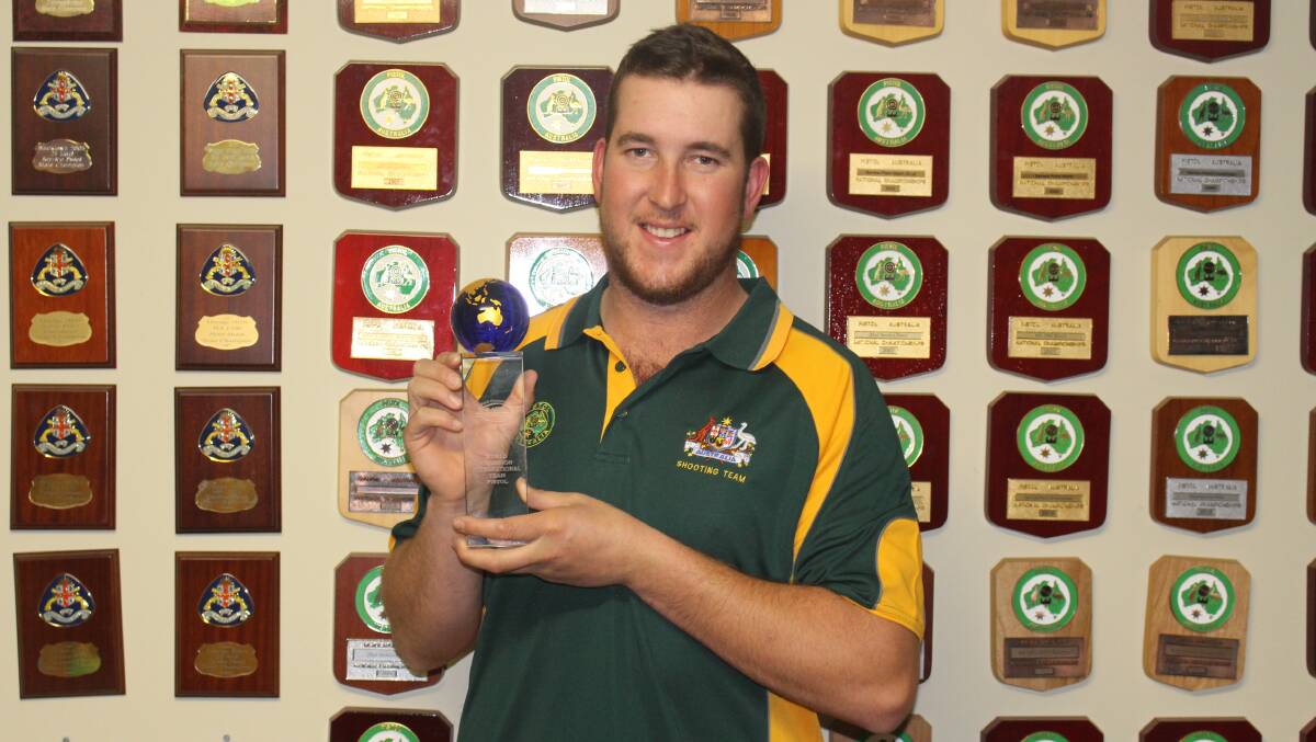PISTOL PETE: Pete Brus with his world pistol shooting trophy from Bowral. 