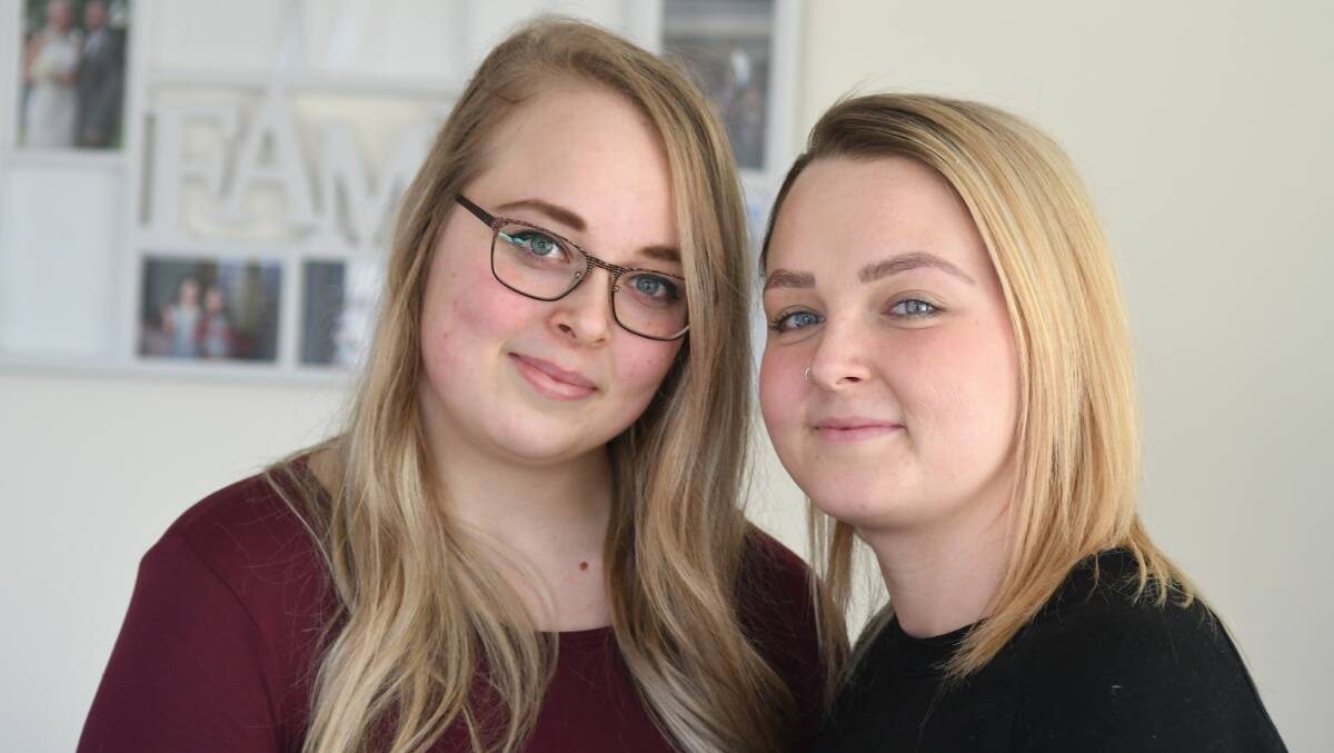 SISTERS TOGETHER: Caitlin and Emily Davis ahead of a fundraiser for surgery on a tumour in Caitlin's neck. Photo: JUDE KEOGH 0809jkfund2.