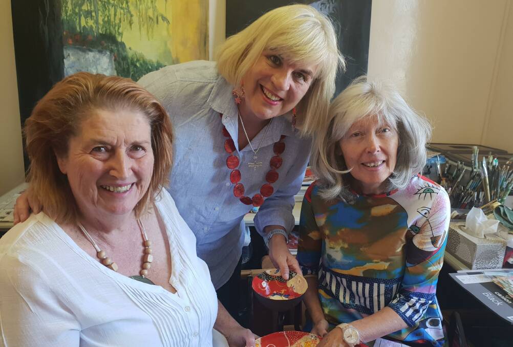 PAINTING FOR PALLIATIVE: Artist Joy Engelman, president of Orange Push for Palliative Care Jenny Hazelton and fellow artist Josephine Jagger-Manners.