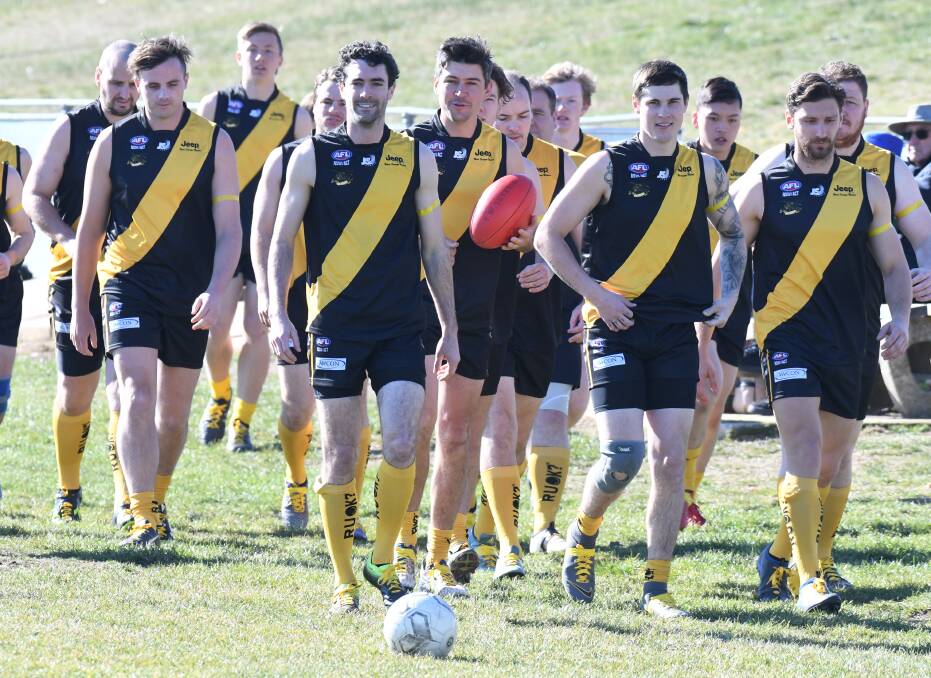 MORE THAN FOOTY: Tigers' captain Mick Evans leads the side out during last year's R U OK Day, with the club having special socks made for the occasion in 2019. Photo: CARLA FREEDMAN