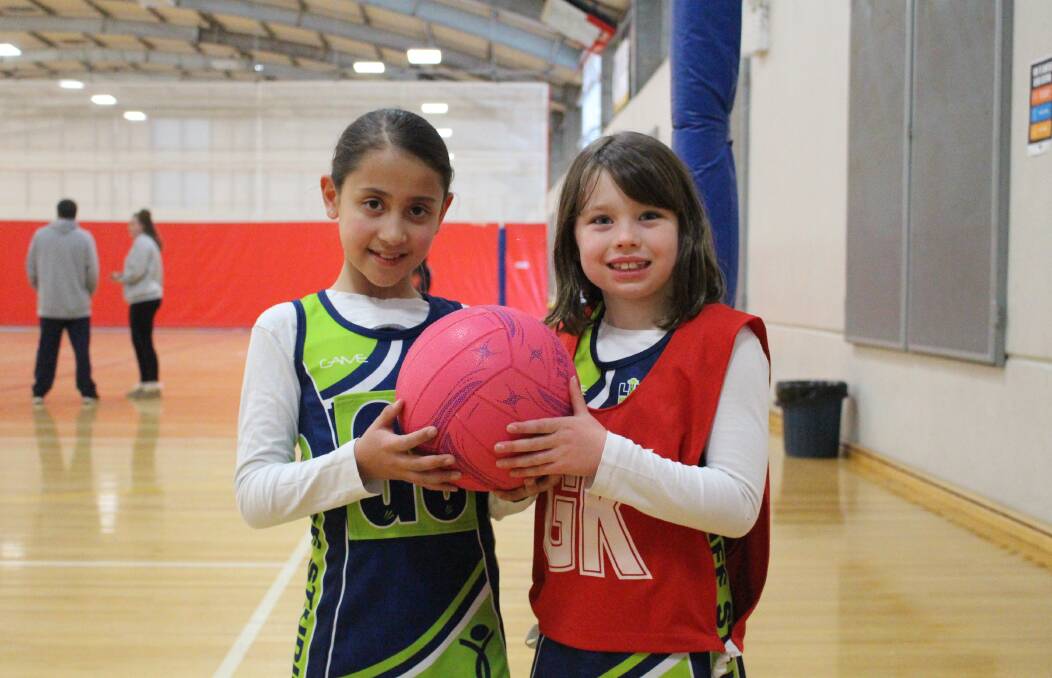 HAVING A BALL: Maddison Porter and Renate Sobotta are two of the hundreds of young girls across Orange who have begun playing netball in the past few years. Photo: MAX STAINKAMPH