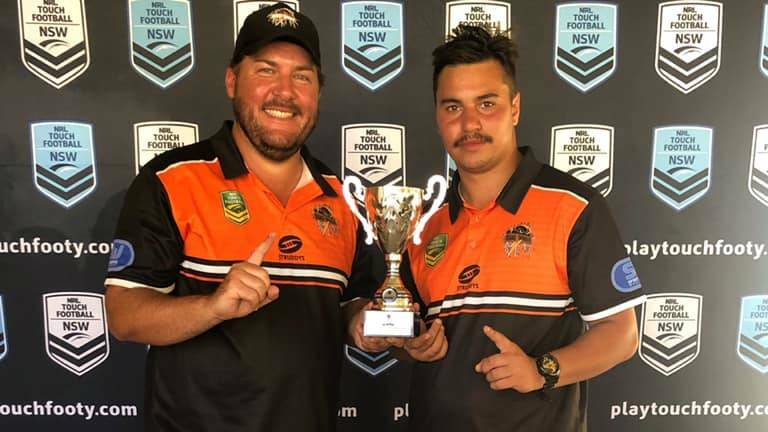 CLUB TITLE: Orange representative director Joel Begnell and coach Mitch Leonard show off their club championship spoils from Febuary. 