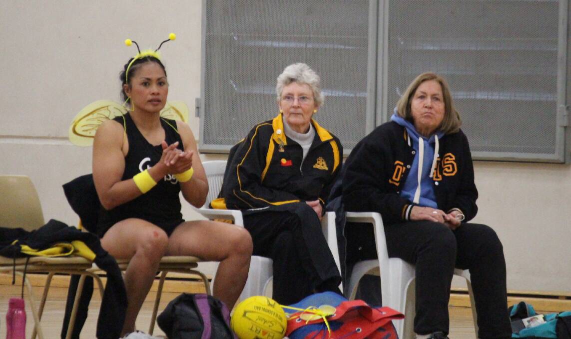 SHOWING SUPPORT: Orange netball royalty in Jacky Lyden, Lynne Middleton and Toot Keegan were on the bench for the Hornets on Saturday. Photo: MAX STAINKAMPH