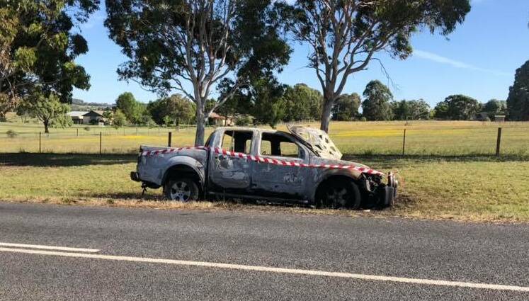 DANGEROUS: The burned-out car along Banjo Paterson Way in Clifton Grove. It's the eighth car set alight this month in Orange and surrounds, and the Rural Fire Service are warning it could spark bushfires. Photo: TROY PHILPOTT. 