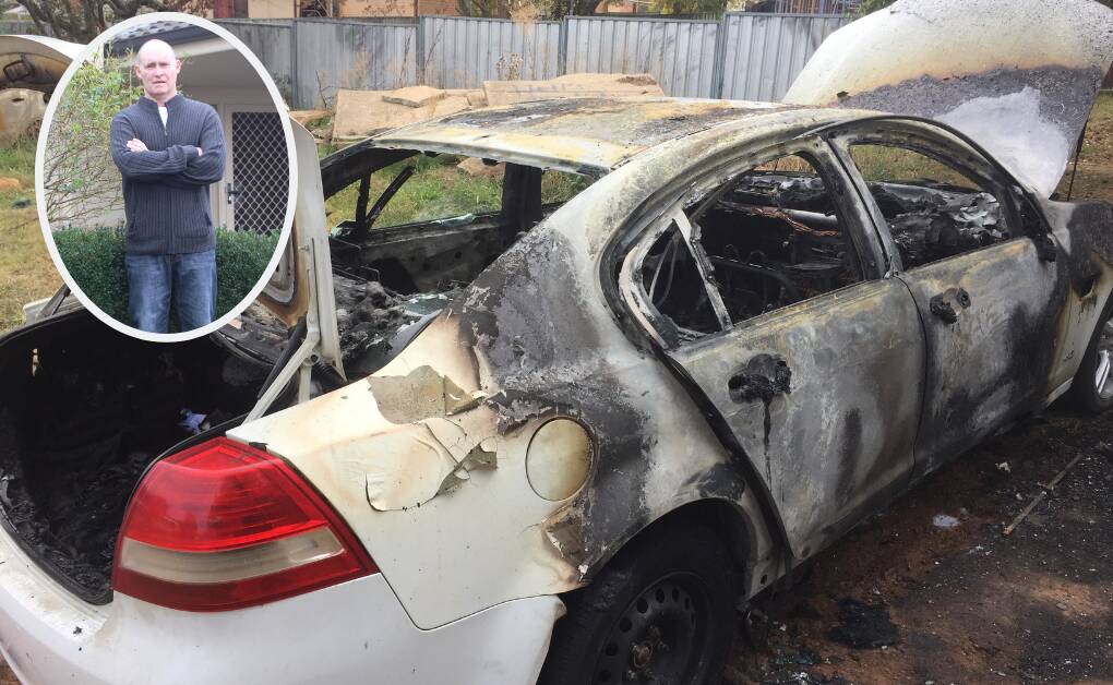 CHARRED WRECK: Greg Thomas' Holden Commodore minutes after it had been set alight in broad daylight on April 24.
