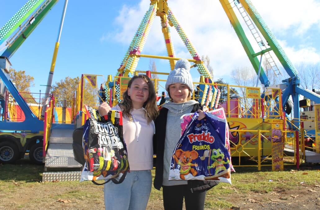 LOVE THE SHOW: Elle Johnson and Tess Hazzard in front of their favourite ride at the Orange Show on Saturday. Photo: MAX STAINKAMPH