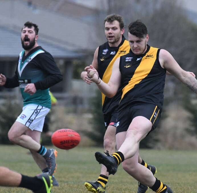 BOOMING LEFT BOOT: Tigers defender Chris Rothnie gets a clearing kick away last week against Bathurst Bushrangers Outlaws at Waratahs Sportsground. Tigers host Dubbo on Saturday. Photo: JUDE KEOGH. 