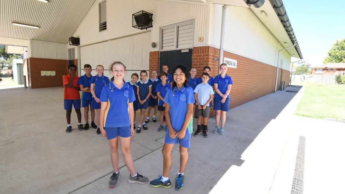 School captains Josie Fuller and Martin Mangsa on Wednesday with fellow students in front of the hall which is due for an upgrade.
