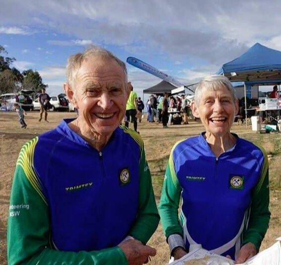 STILL GOING STRONG: Basil and Jean Baldwin in action with maps in hand at an Orienteering event. Photo: SUPPLIED. 