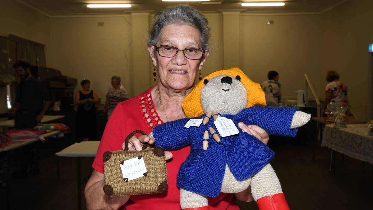 STAR OF THE SHOW: Helen Woods props up Paddington Bear and his suitcase at the CWA Hall in Robertson Park on Monday. Photo: CARLA FREEDMAN