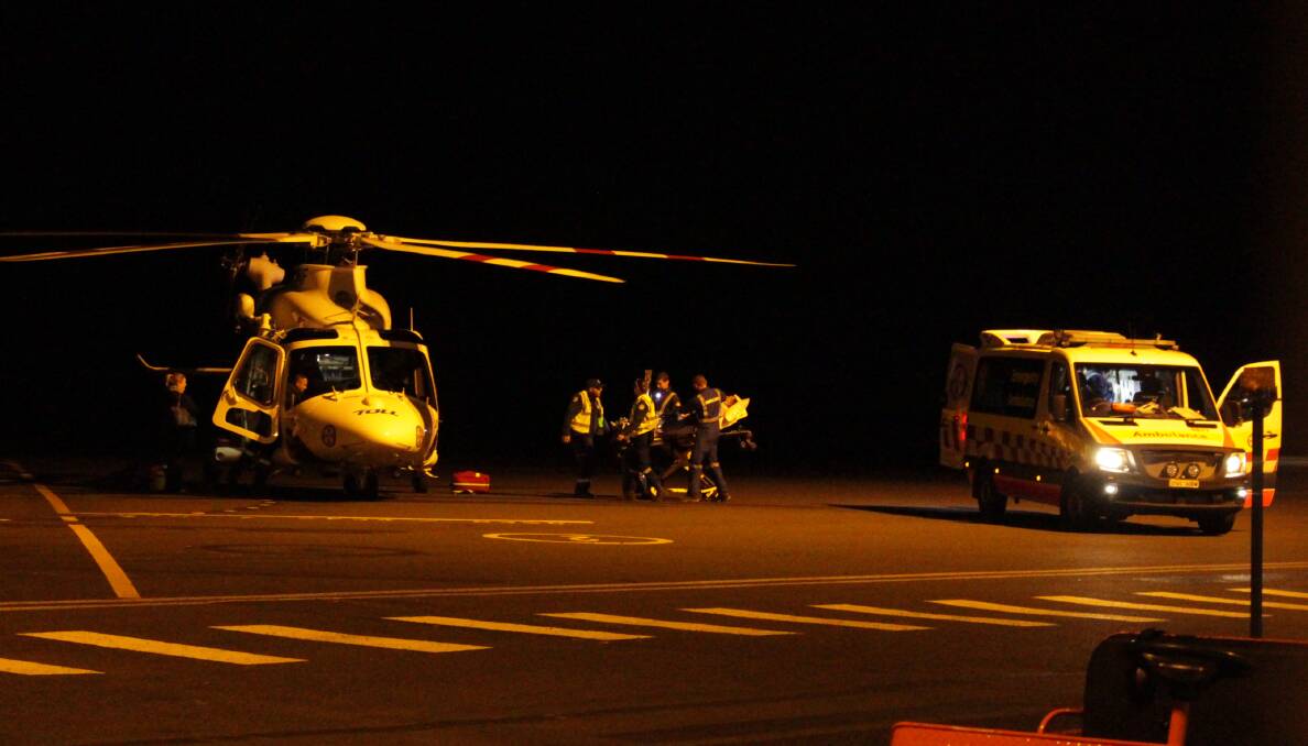 IN ACTION: Emergency services loading preparing transport to Sydney. Photo: MAX STAINKAMPH. 