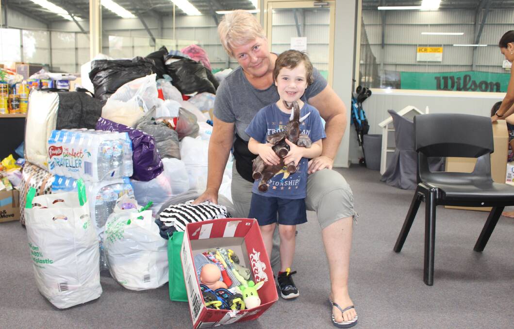 ABSOLUTE LEGEND: Elliot Brown with Toni Greenway after the duo donated toys and clothes to the bushfire relief effort. Photo: MAX STAINKAMPH
