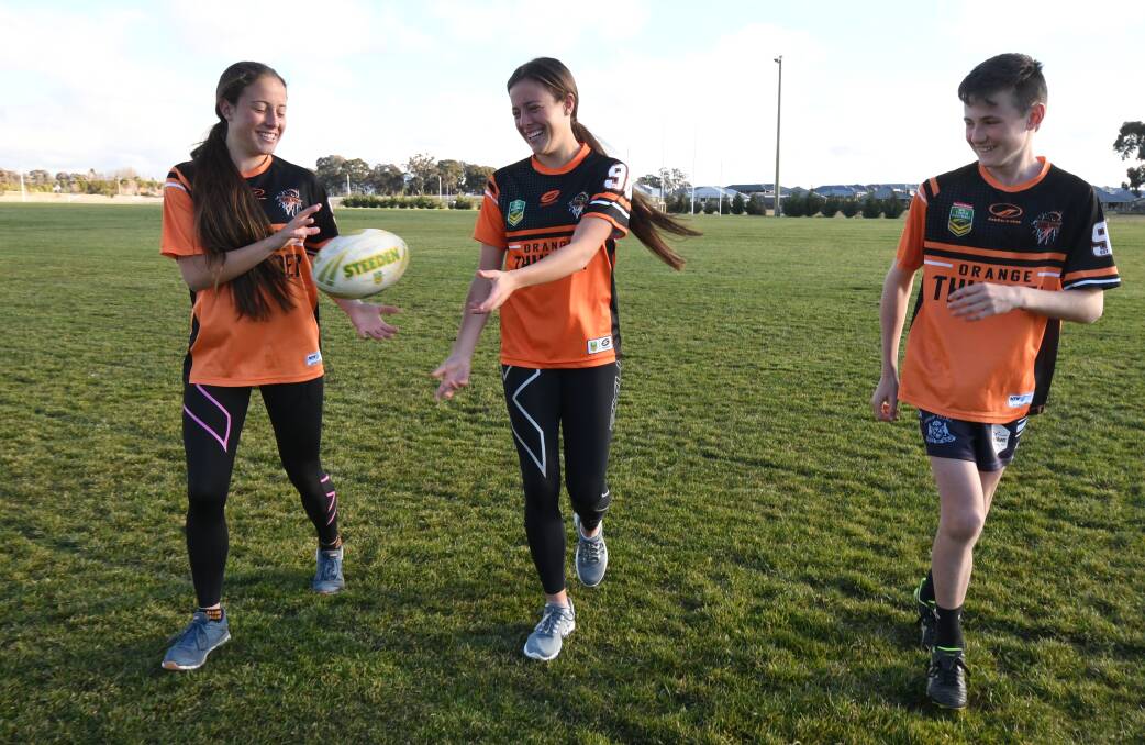 READY FOR ACTION: Under-16 Orange players Caitlin and Hailey Prestwidge with under-14s' Jack Dean. Photo: JUDE KEOGH