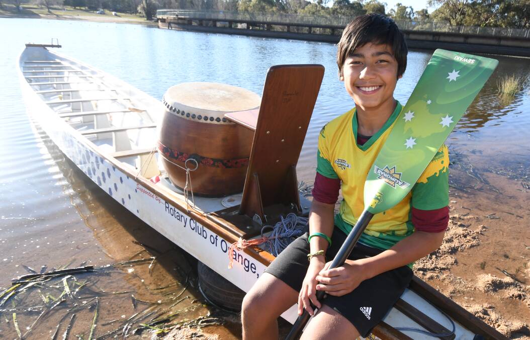 HAPPY RETURNS: Isaac Sewak on the dragonboat at Lake Canobolas, having returned from Thailand with a swathe of medals. Photo: JUDE KEOGH