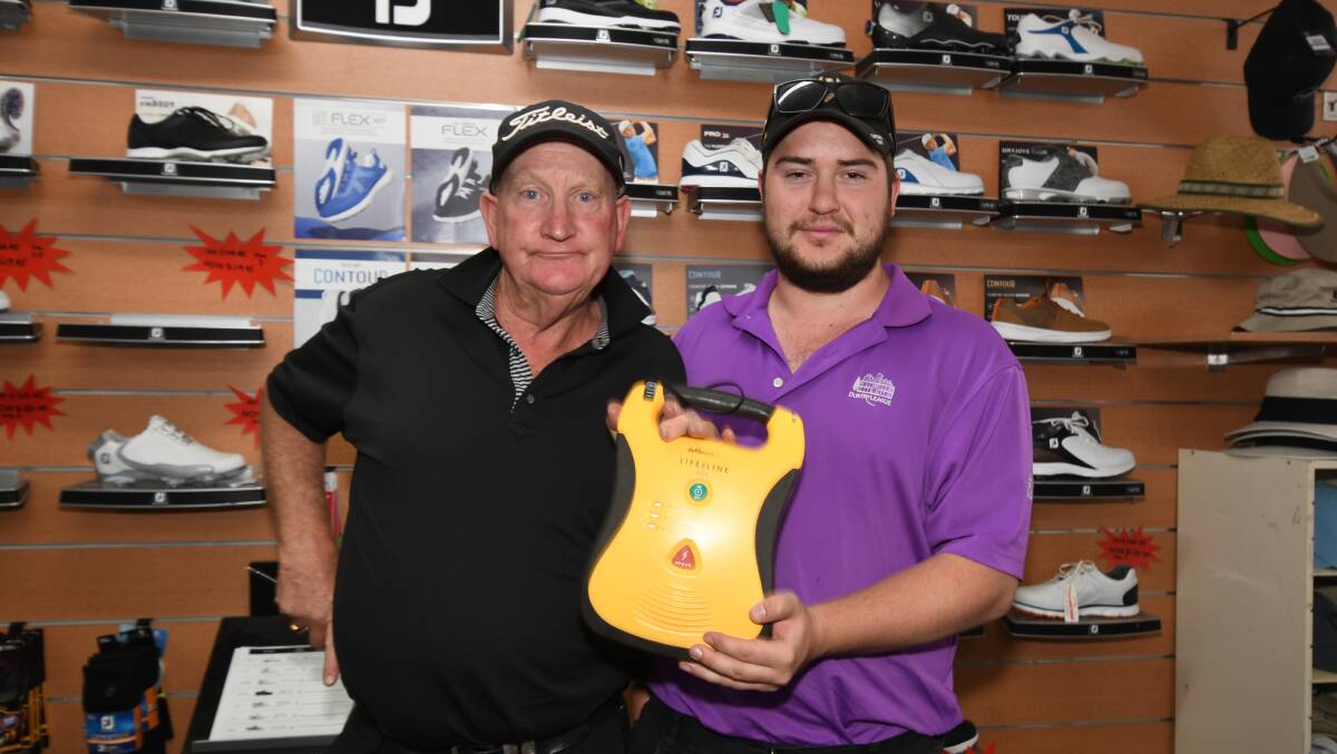 HEART STARTERS: Duntryleague Pro Shop's Johny Furze and Brody Taylor with the club's defibrillator. Photo: CARLA FREEDMAN. 