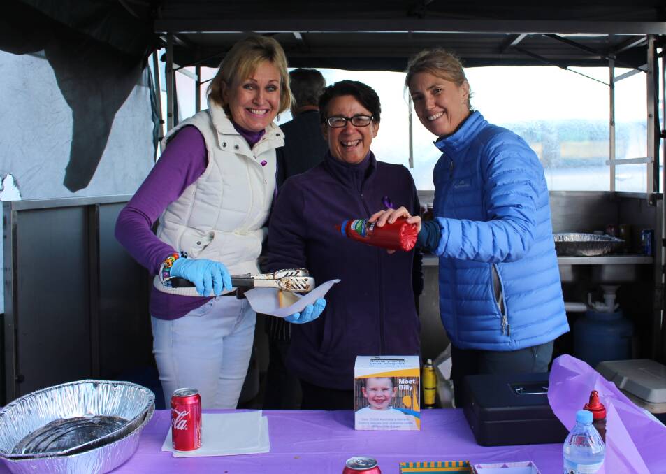 WHAT'S COOKING: Helen Moon, Cassandra Anslow and Wendy McKern were cooking snags to raise awareness and funds for Crohn's and Colitis Australia. Photo: MAX STAINKAMPH