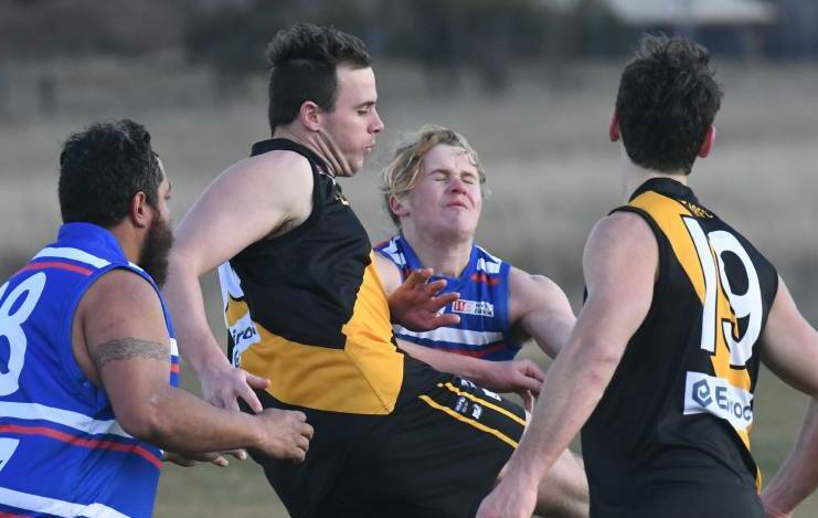 CLEARING KICK: Tiger defender Callan Hunt kicks clear of a pack in a game against Parkes. He plays game number 50 on Saturday. Photo: JUDE KEOGH