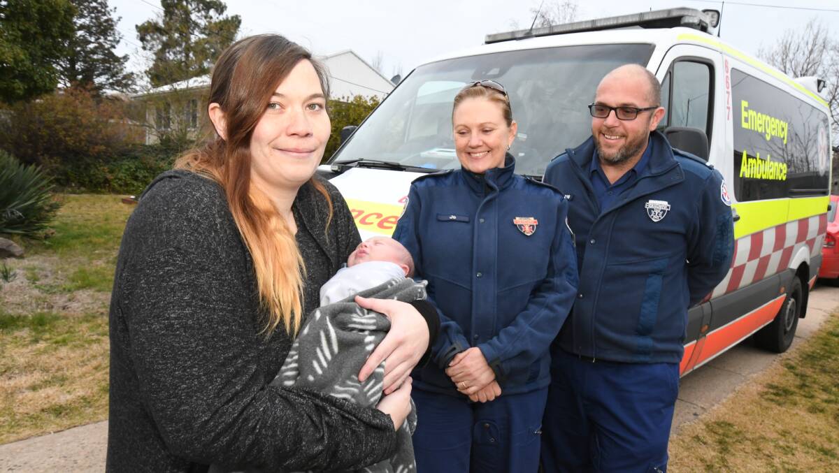 Rachel Campbell and Dusty Jeffery meeting paramedics two weeks after Dusty's birth. Photos: JUDE KEOGH