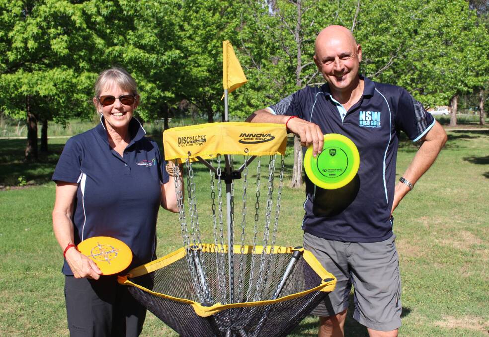 HOLE IN ONE: Sharon and Kevin Costa show off a target for disc golf. Photo: MAX STAINKAMPH