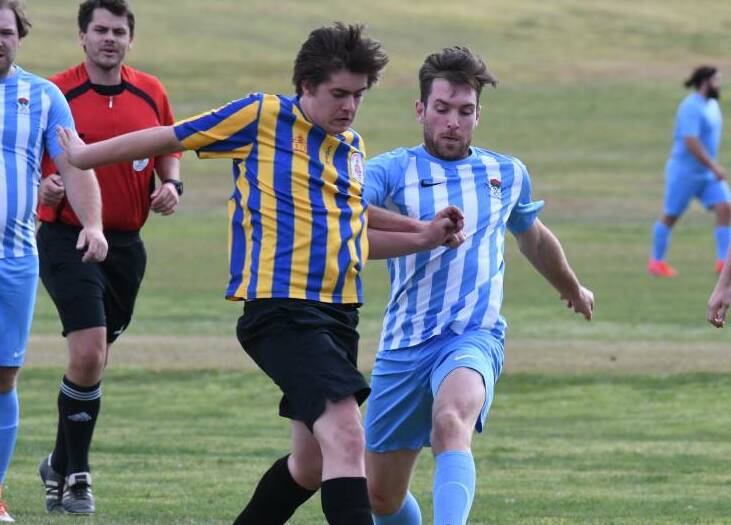 CLASH IS ON: Waratahs' Adam Kelly (right) slides in to lay a tackle during season 2019 in the Orange District Football Association. Photo: JUDE KEOGH
