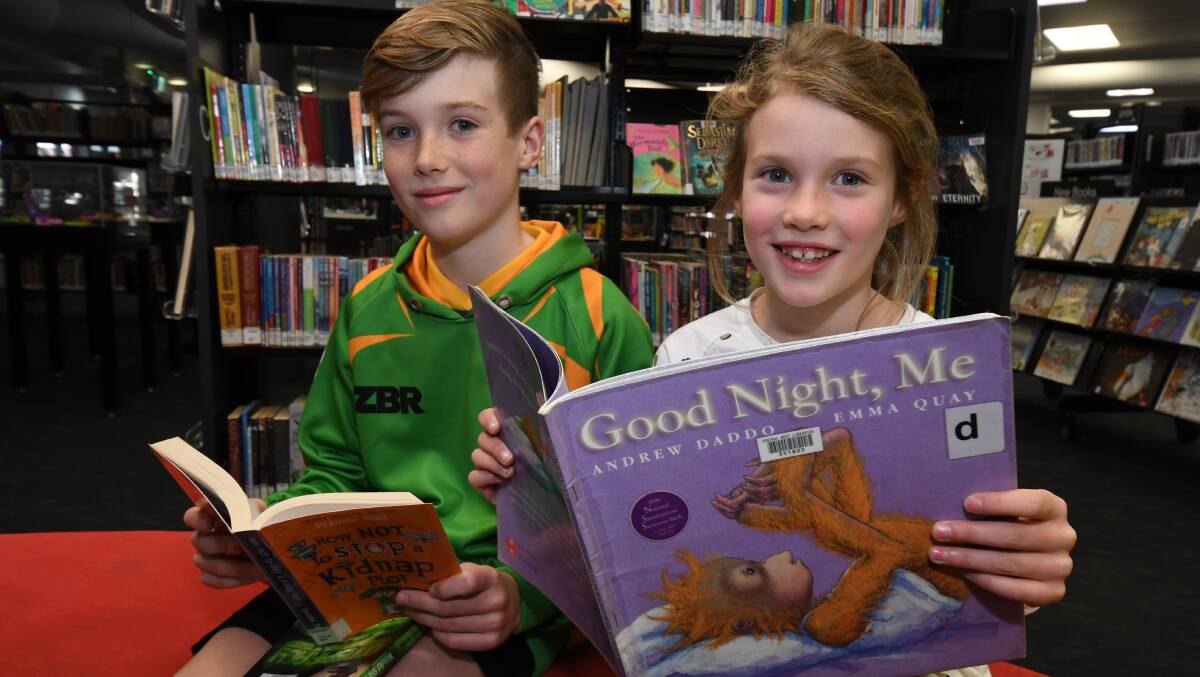 HAPPY READING: Xavi and Ivy Wynne at the Orange library getting their fix of reading. The library is considering live-streaming bedtime stories. Photo: JUDE KEOGH 0719jkread1 