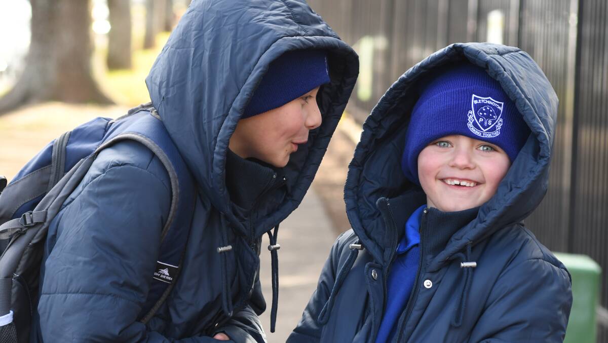 RUGGED UP: Bletchington Public School students Hayden and Caleb Fletcher were snug as a bug, wrapped up in coats and beanies to avoid the cold on Friday. Photo: JUDE KEOGH