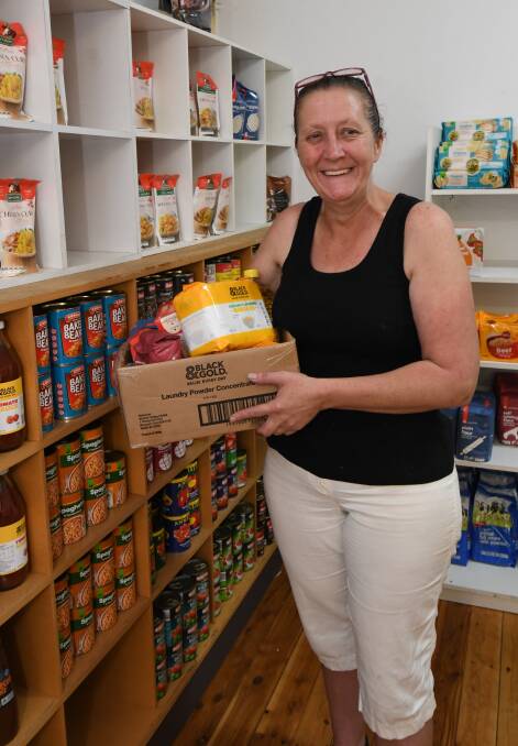 LAUNCHED: Karlie Irwin with a box-full of goods in the Pay It Forward Community Food Bank, which launched this week. Photo: JUDE KEOGH. 