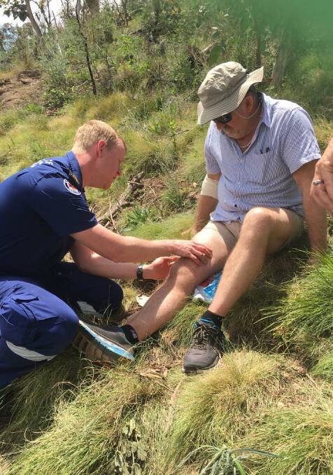 Owen Dowdell being treated by a paramedic on Sunday up Mount Canobolas. Photo: BARBARA MILLIST
